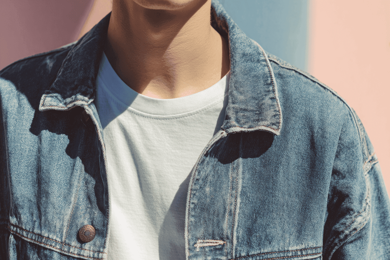 Person wearing a white T-shirt and denim jacket